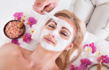 Woman during a facial treatment at a Med Spa.